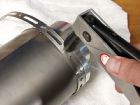 Insert new riverts into muffler to secure end cap